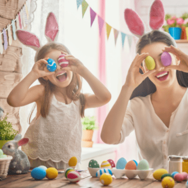 Mom and daughter with Easter bunny ears and eggs